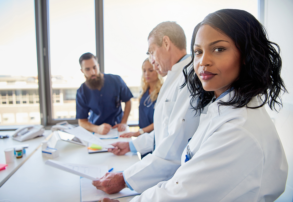 a black lady doctor and a white person looking after patient