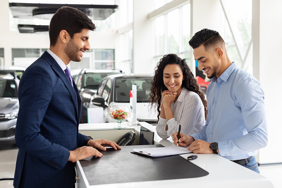 Wealthy arab family buying new car in showroom