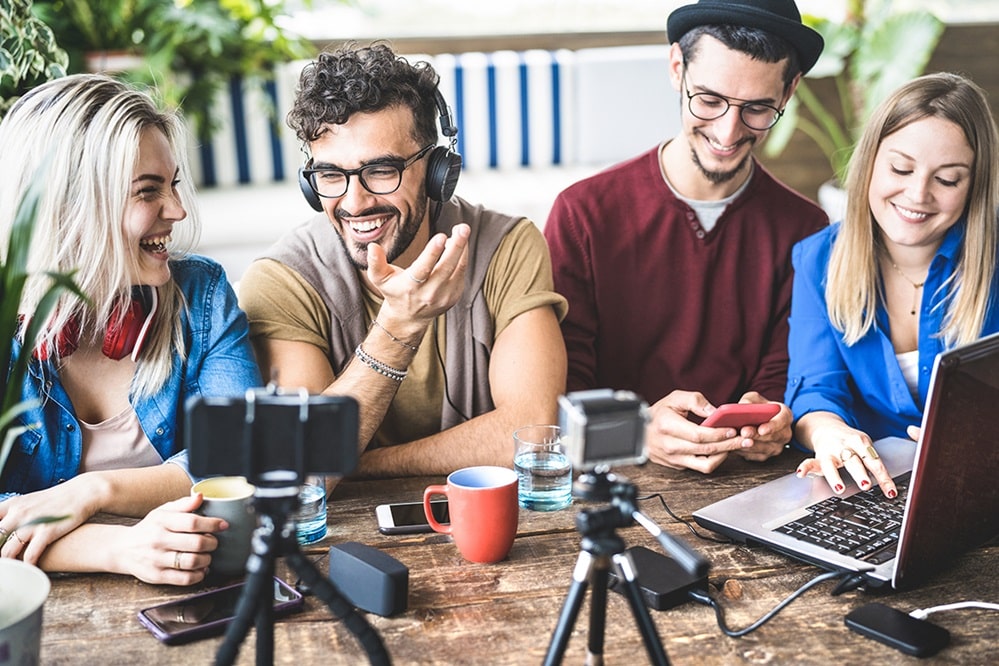 Young happy friends sharing content